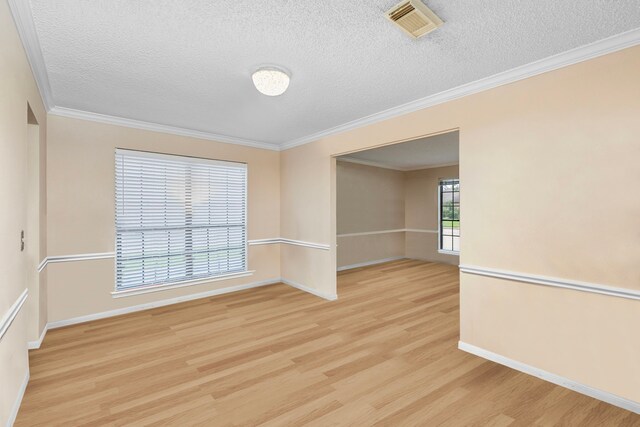 spare room featuring light hardwood / wood-style flooring and ornamental molding