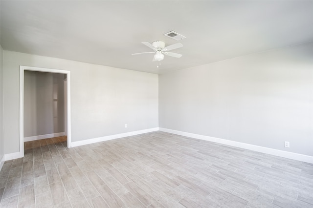 empty room with light hardwood / wood-style floors and ceiling fan