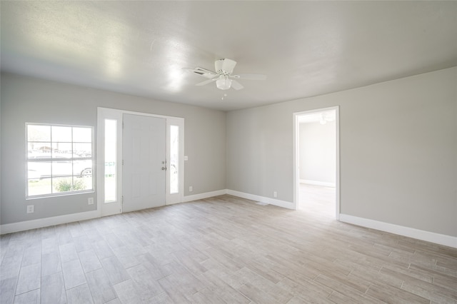 spare room with light hardwood / wood-style floors and ceiling fan