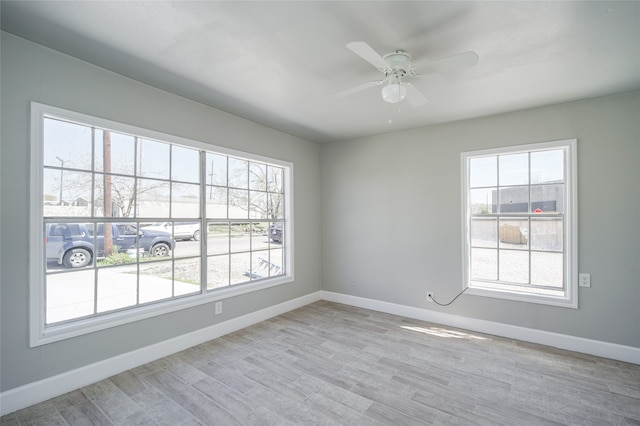 spare room with ceiling fan and light hardwood / wood-style flooring