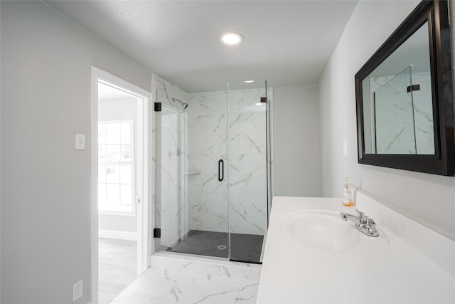 bathroom featuring walk in shower and vanity