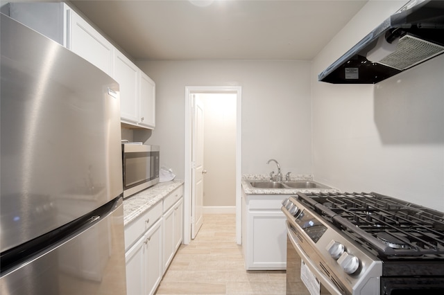 kitchen with sink, extractor fan, stainless steel appliances, and white cabinets