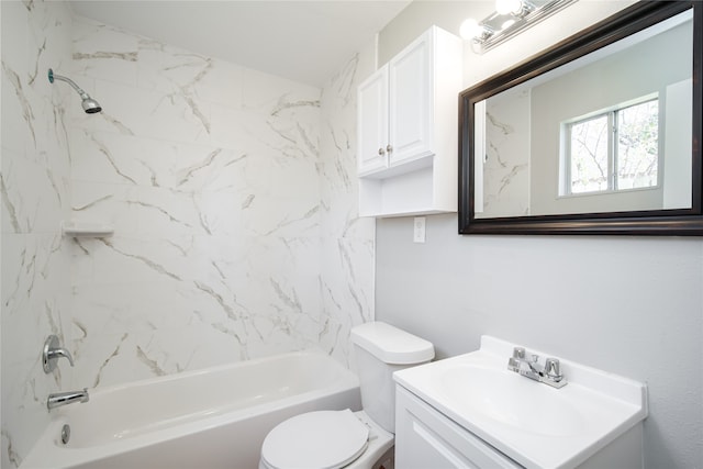 full bathroom with tiled shower / bath, vanity, and toilet