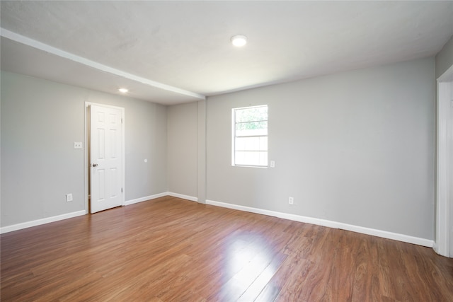 unfurnished room with hardwood / wood-style floors