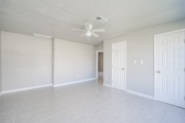 unfurnished bedroom featuring ceiling fan, a textured ceiling, and light tile patterned flooring