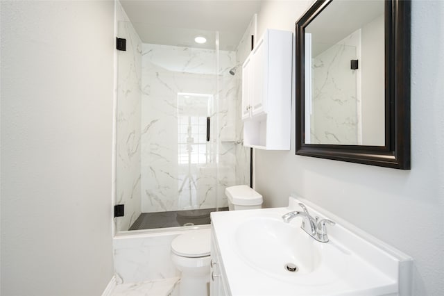 bathroom with vanity, an enclosed shower, and toilet