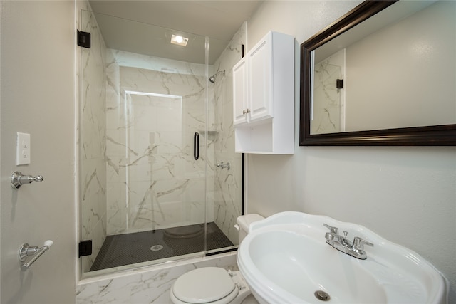 bathroom featuring sink, toilet, and an enclosed shower