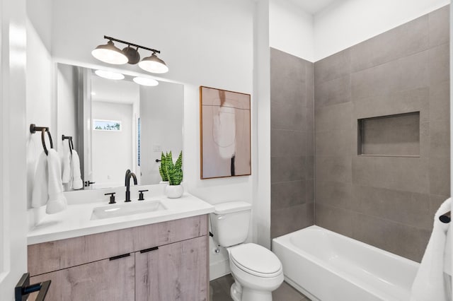 full bathroom with tiled shower / bath, vanity, and toilet