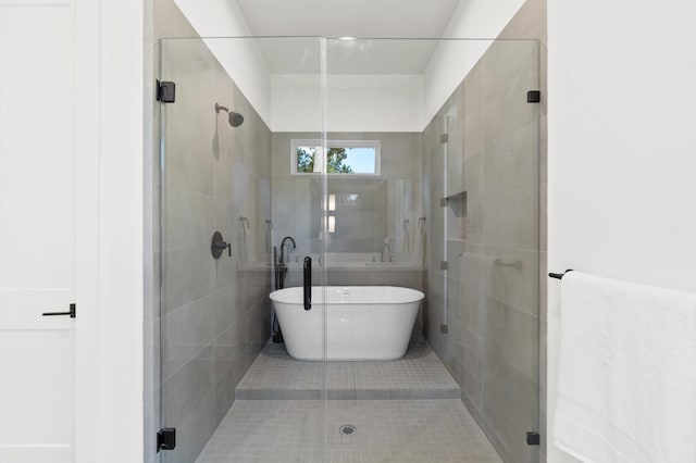 bathroom with shower with separate bathtub and tile patterned flooring