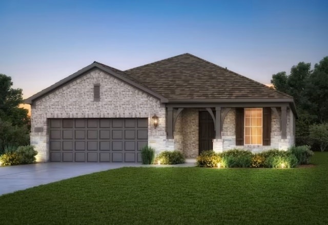 view of front of home featuring a garage and a lawn