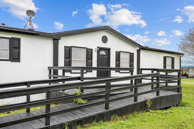 exterior space with a wooden deck and a yard