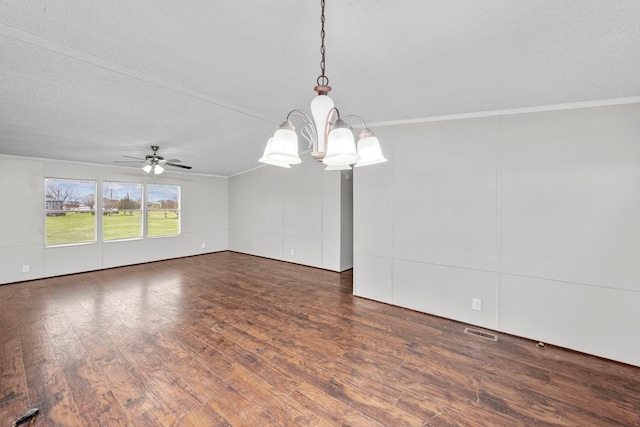 spare room with a textured ceiling, ceiling fan with notable chandelier, ornamental molding, and dark wood-type flooring