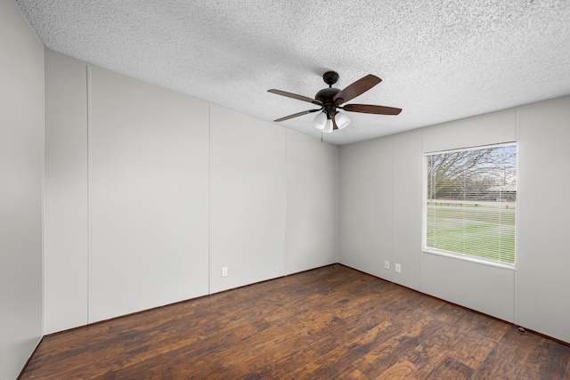 unfurnished room with a textured ceiling, dark hardwood / wood-style floors, and ceiling fan