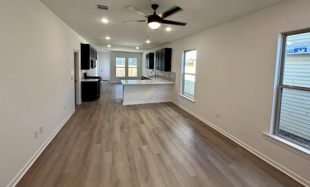 kitchen featuring visible vents, dark wood-style floors, light countertops, baseboards, and dark cabinets