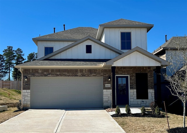 view of front of home with board and batten siding, fence, concrete driveway, roof with shingles, and an attached garage