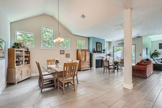 dining area featuring lofted ceiling and a notable chandelier