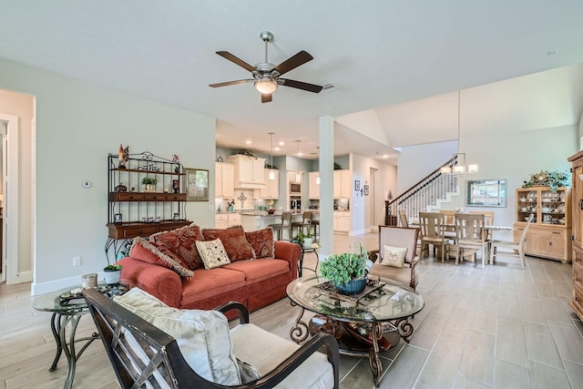 13224 N Salmon River Cir, Humble, TX 77346 - living area featuring visible vents, ceiling fan with notable chandelier, stairway, and light wood-type flooring
