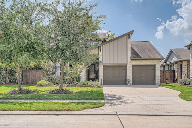 view of front of house with a front yard and a garage