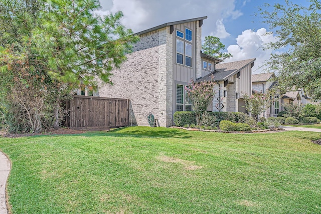 13224 N Salmon River Cir, Humble, TX 77346 - view of home's exterior featuring fence, a lawn, and board and batten siding