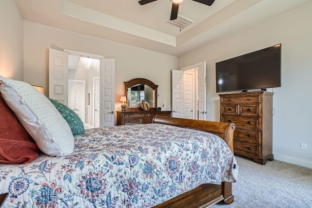 13224 N Salmon River Cir, Humble, TX 77346 - bedroom with visible vents, a ceiling fan, a tray ceiling, carpet flooring, and baseboards