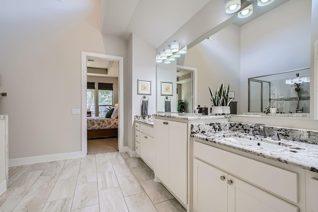 13224 N Salmon River Cir, Humble, TX 77346 - ensuite bathroom with baseboards, two vanities, a sink, a shower stall, and connected bathroom