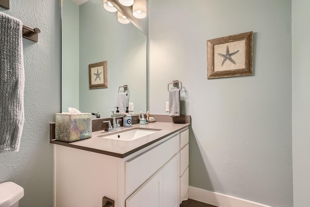 bathroom with toilet and vanity