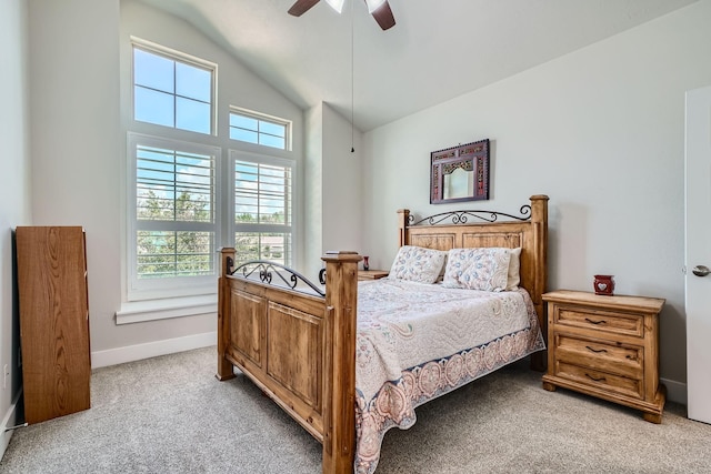 bedroom featuring baseboards, lofted ceiling, light colored carpet, and ceiling fan