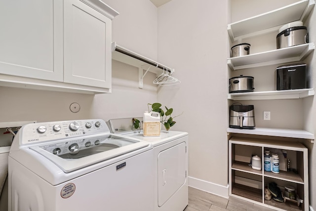 laundry room with cabinets and washer and dryer