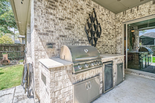 view of patio / terrace with exterior kitchen and a grill