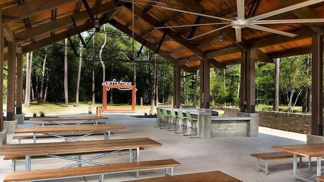 view of property's community featuring a gazebo, a patio, and outdoor dry bar