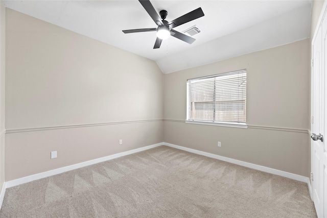 unfurnished room featuring light carpet, vaulted ceiling, and ceiling fan