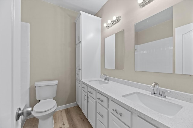 bathroom featuring hardwood / wood-style flooring, vanity, and toilet