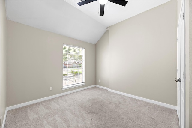 carpeted spare room featuring ceiling fan and lofted ceiling