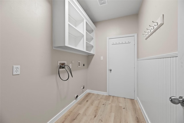 washroom featuring electric dryer hookup, gas dryer hookup, light hardwood / wood-style flooring, and washer hookup