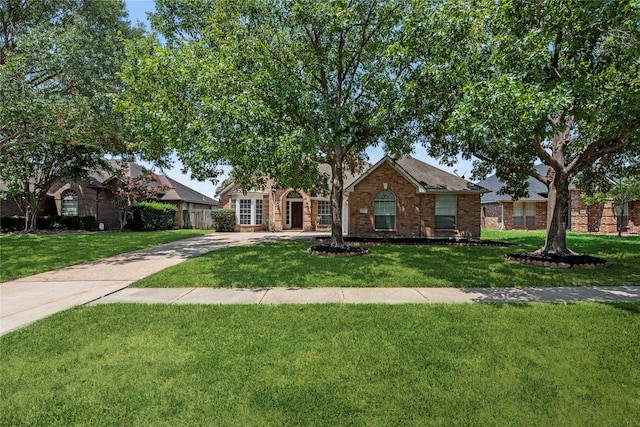 ranch-style home featuring a front lawn