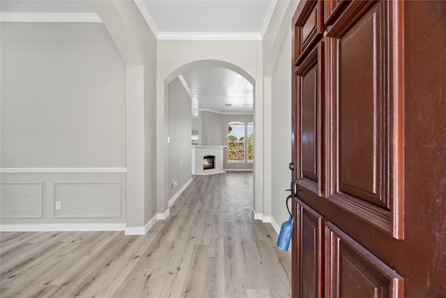 entryway featuring crown molding and light hardwood / wood-style floors