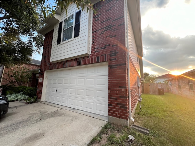 view of side of home with a yard and a garage