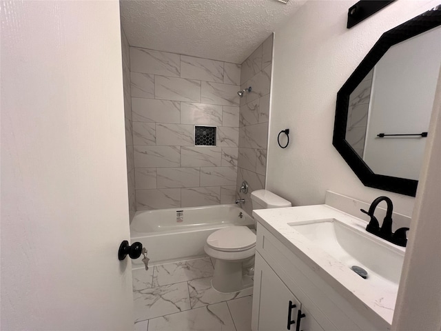 full bathroom with a textured ceiling, tiled shower / bath combo, vanity, and toilet