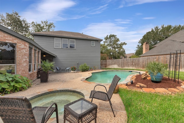view of swimming pool with a fenced backyard, a jacuzzi, a patio area, and a fenced in pool