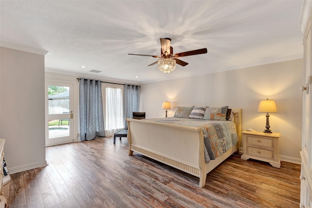 bedroom featuring access to exterior, visible vents, baseboards, wood finished floors, and crown molding
