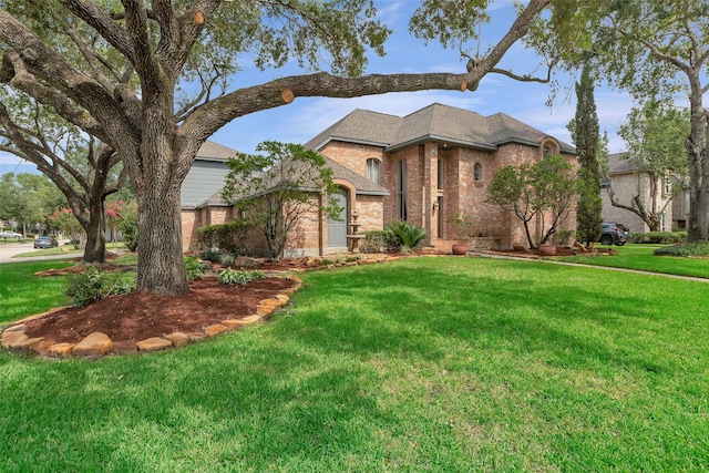 view of front of home with brick siding and a front yard
