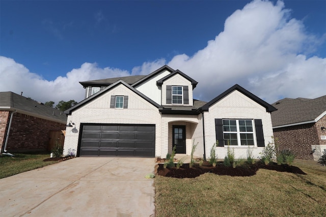 view of front of house featuring a garage and a front lawn