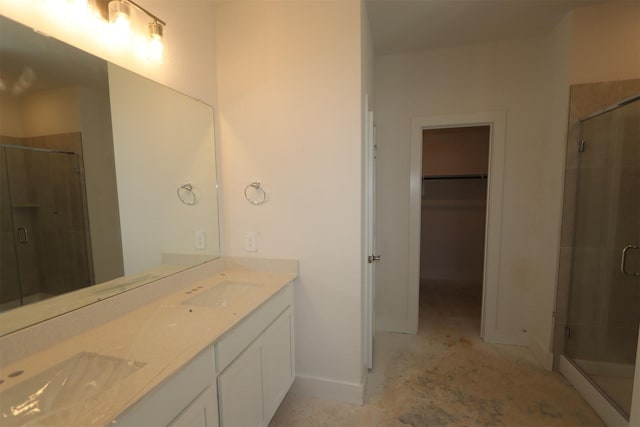 bathroom featuring vanity and a shower with shower door