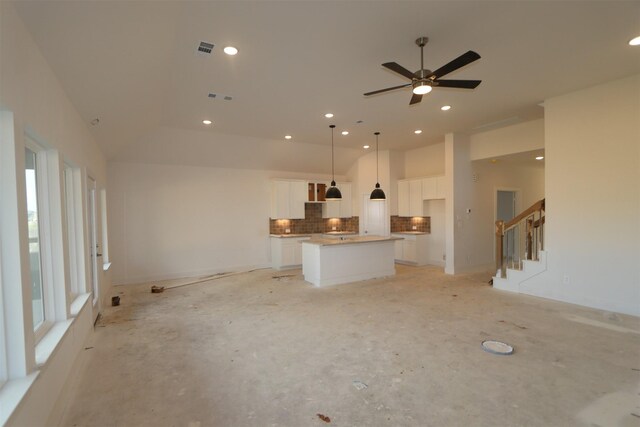 unfurnished living room featuring ceiling fan