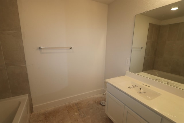 bathroom featuring vanity and a tub