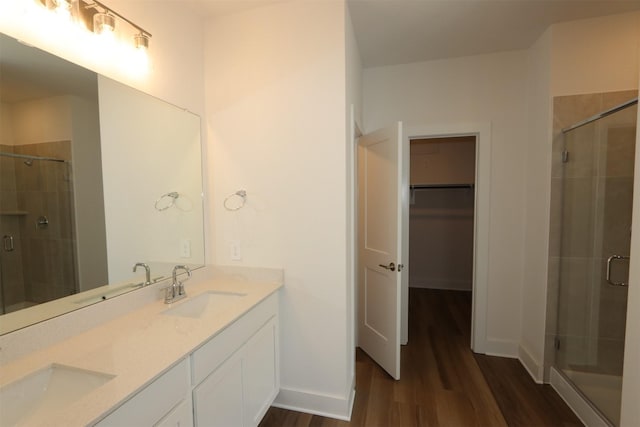 bathroom with a sink and a stall shower