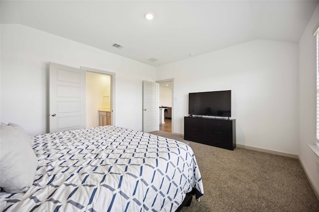 bedroom featuring carpet, connected bathroom, and vaulted ceiling