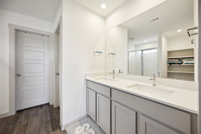 bathroom featuring vanity, hardwood / wood-style flooring, and an enclosed shower