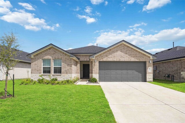 ranch-style house featuring a garage and a front yard