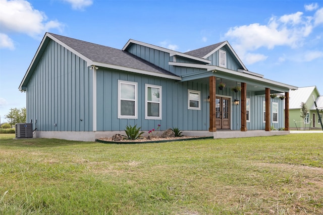 view of front of home with a porch, central air condition unit, and a front yard